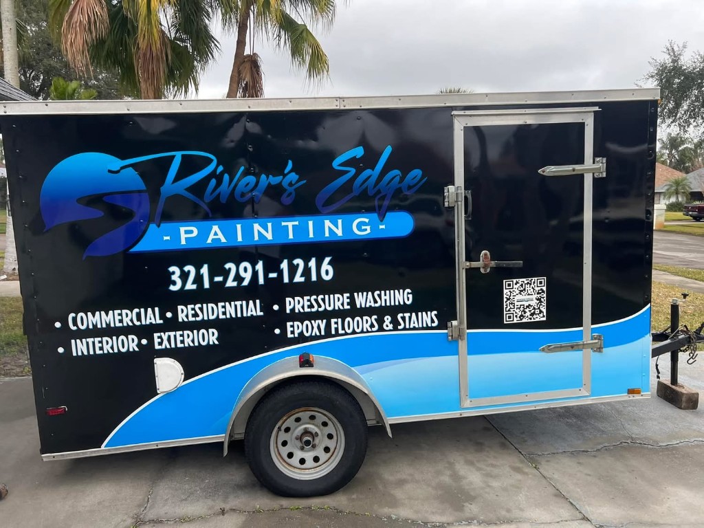 Rivers Edge Painting wrapped trailer showing the company logo, phone number 321-291-1216, and services offered